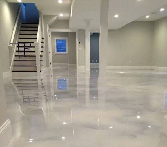 Commercial epoxy flooring contractor applying coating to warehouse floor
